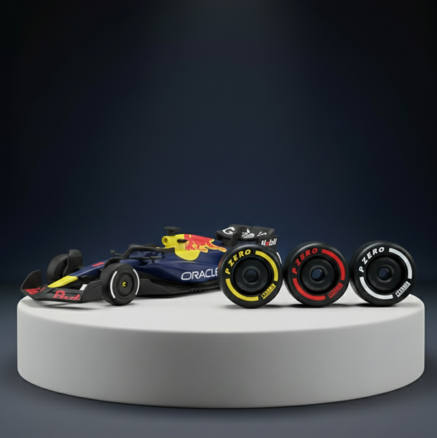 Model Formula 1 car with three wheels on a white platform against a dark background